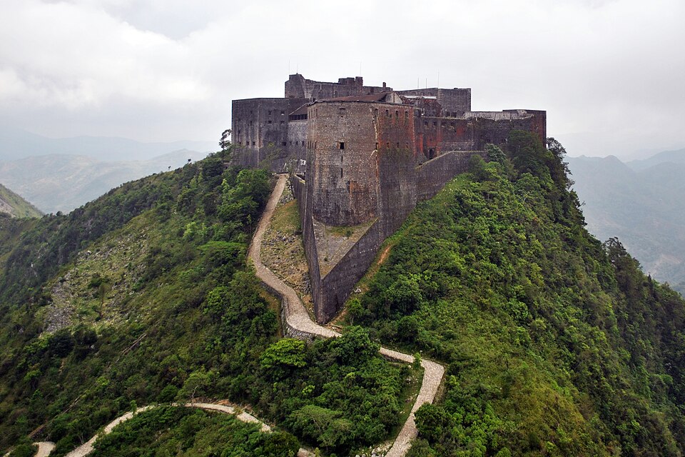 Aerial view of the Citadelle Laferrière fortress on a green mountain peak in northern Haiti